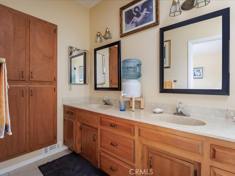 1912 Chester Lane Cambria, CA 93428 - Photo 19 of 41 a bathroom with a double vanity sink and a mirror