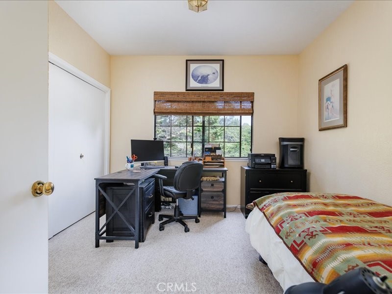 1912 Chester Lane Cambria, CA 93428 - Photo 23 of 41 a bedroom with a bed and a desk