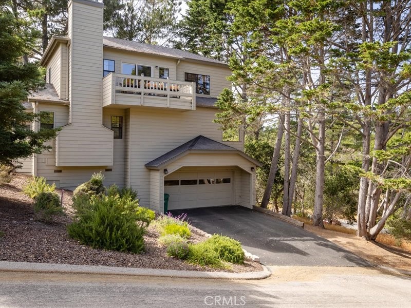 1912 Chester Lane Cambria, CA 93428 - Photo 31 of 41 a front view of a house with a yard garage and outdoor seating