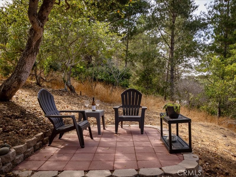 1912 Chester Lane Cambria, CA 93428 - Photo 33 of 41 a backyard of a house with table and chairs