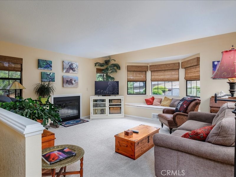1912 Chester Lane Cambria, CA 93428 - Photo 7 of 41 a living room with fireplace furniture and a flat screen tv