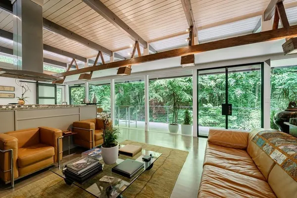 a living room with furniture and floor to ceiling windows