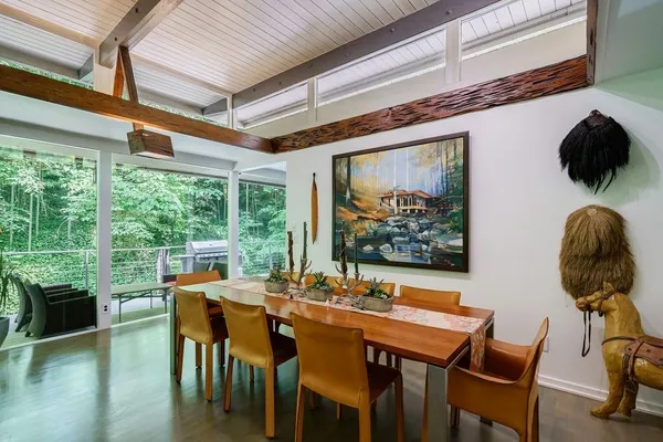 a bedroom with furniture and a large window