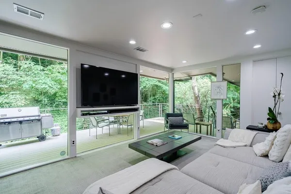 a bedroom with a bed and a large window