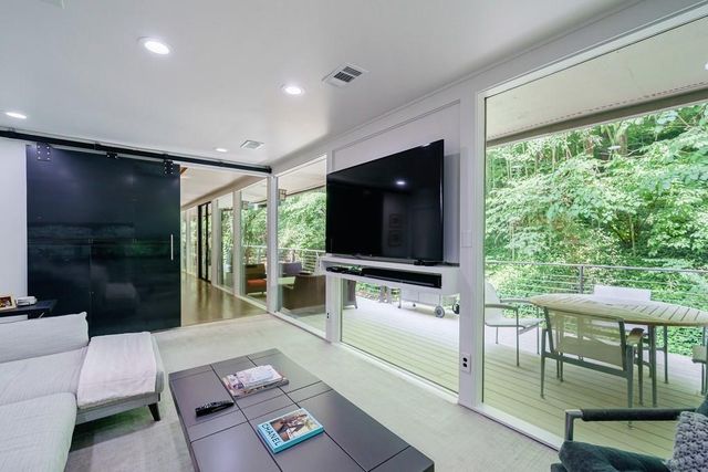 a bedroom with a bed and a large window