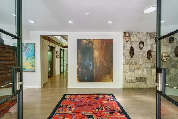 a living room with furniture and a floor to ceiling window