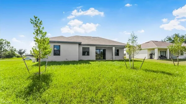 a view of house with a backyard