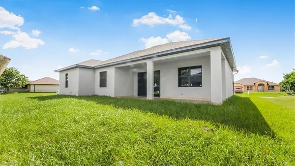a front view of house with yard and green space