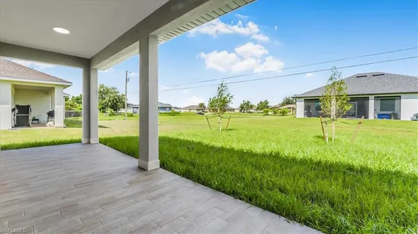 a kitchen with kitchen island stainless steel appliances a sink a stove top oven a counter space and cabinets