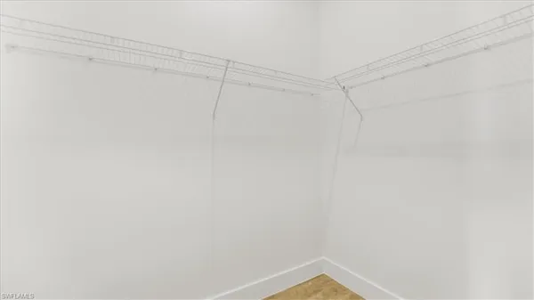 a view of a kitchen with refrigerator and a window
