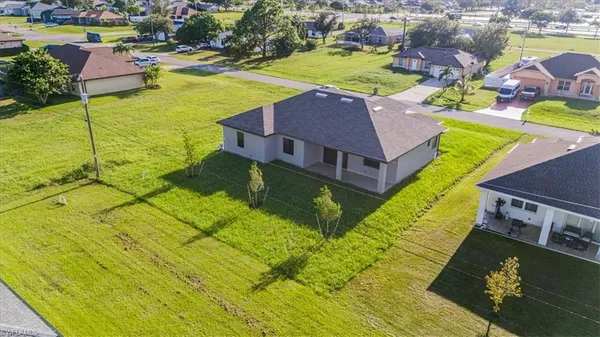 an aerial view of residential houses with outdoor space