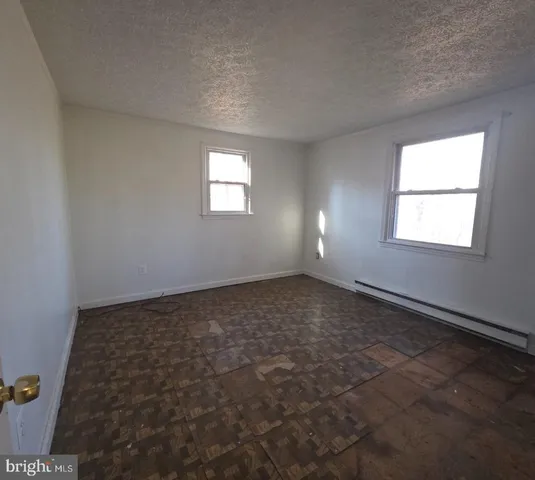 an empty room with a empty space and windows