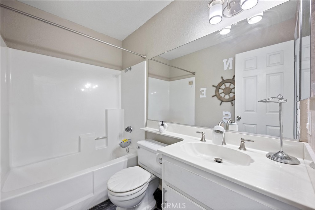 352 Red Spruce Place Perris, CA 92570 - Photo 13 of 30 a bathroom with a sink a toilet and shower