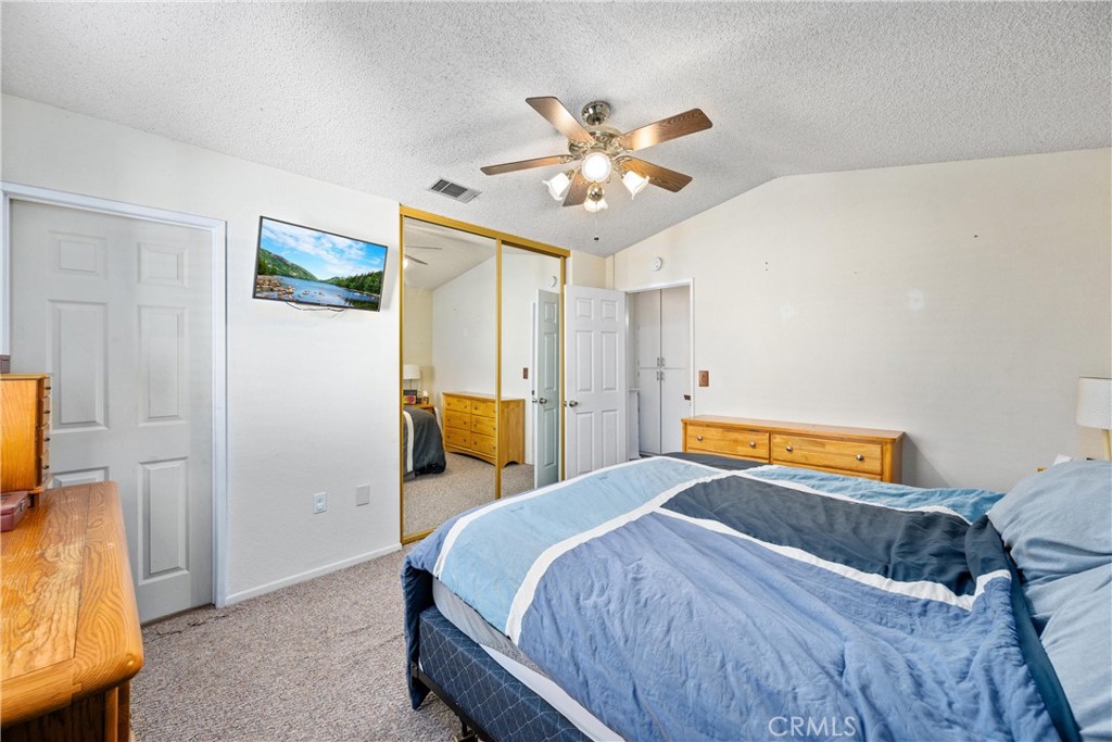 352 Red Spruce Place Perris, CA 92570 - Photo 14 of 30 a bedroom with a bed and a chandelier