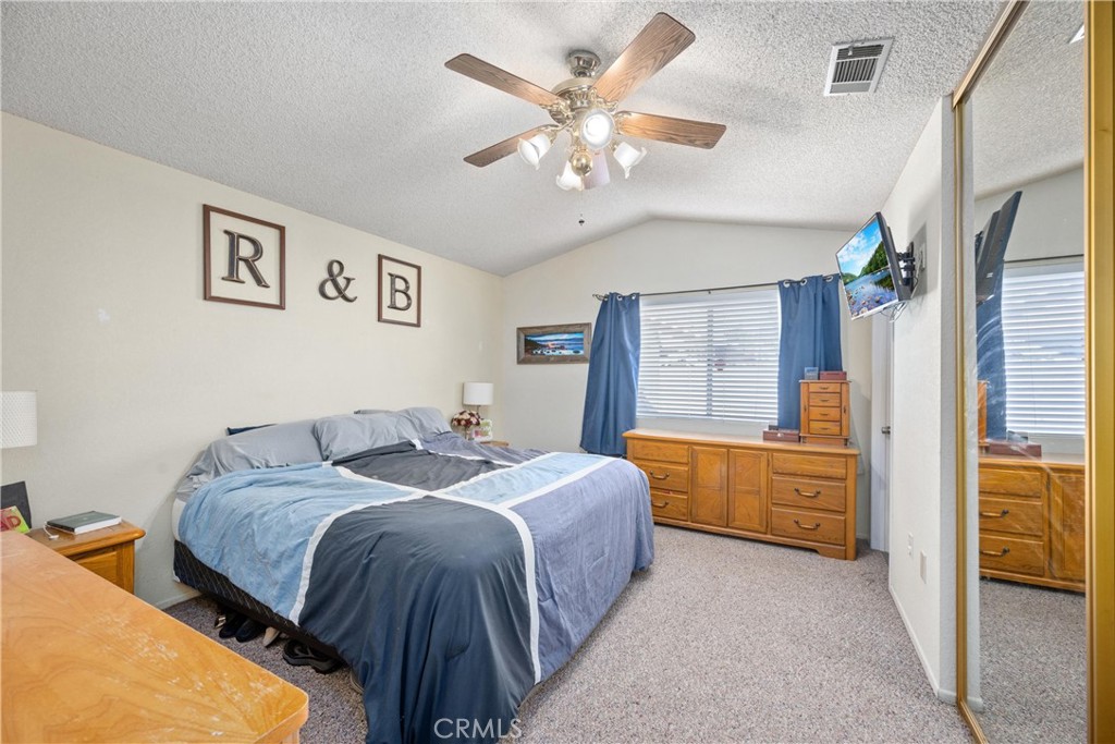 352 Red Spruce Place Perris, CA 92570 - Photo 15 of 30 a bedroom with a large bed couch and window
