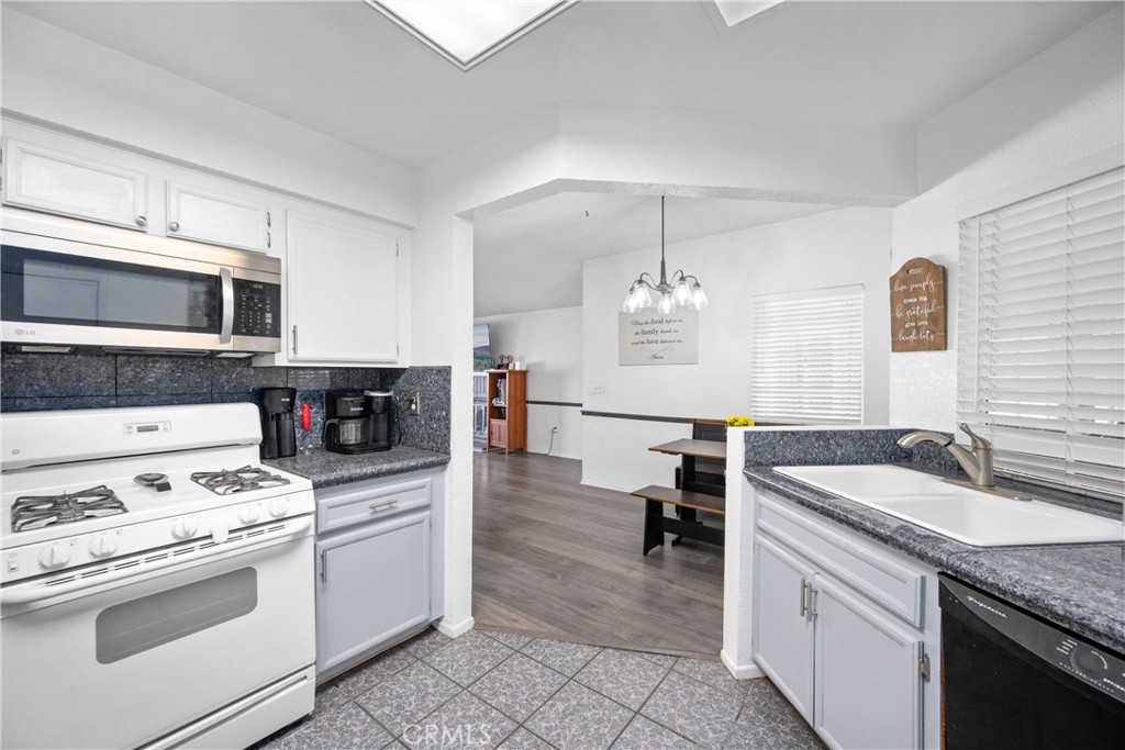 352 Red Spruce Place Perris, CA 92570 - Photo 2 of 30 a kitchen with granite countertop a sink appliances and cabinets