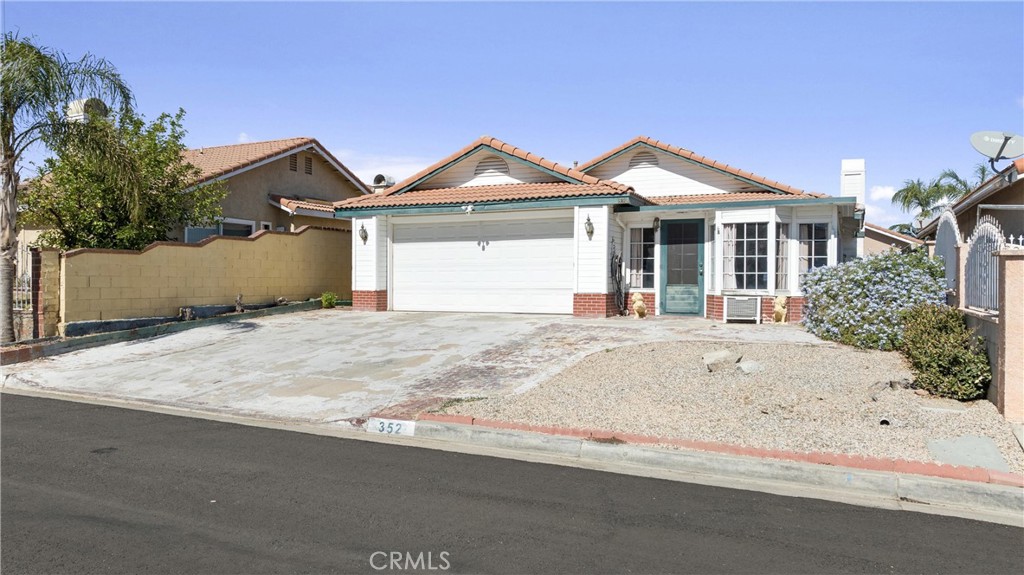 352 Red Spruce Place Perris, CA 92570 - Photo 23 of 30 a front view of a house with a yard and garage