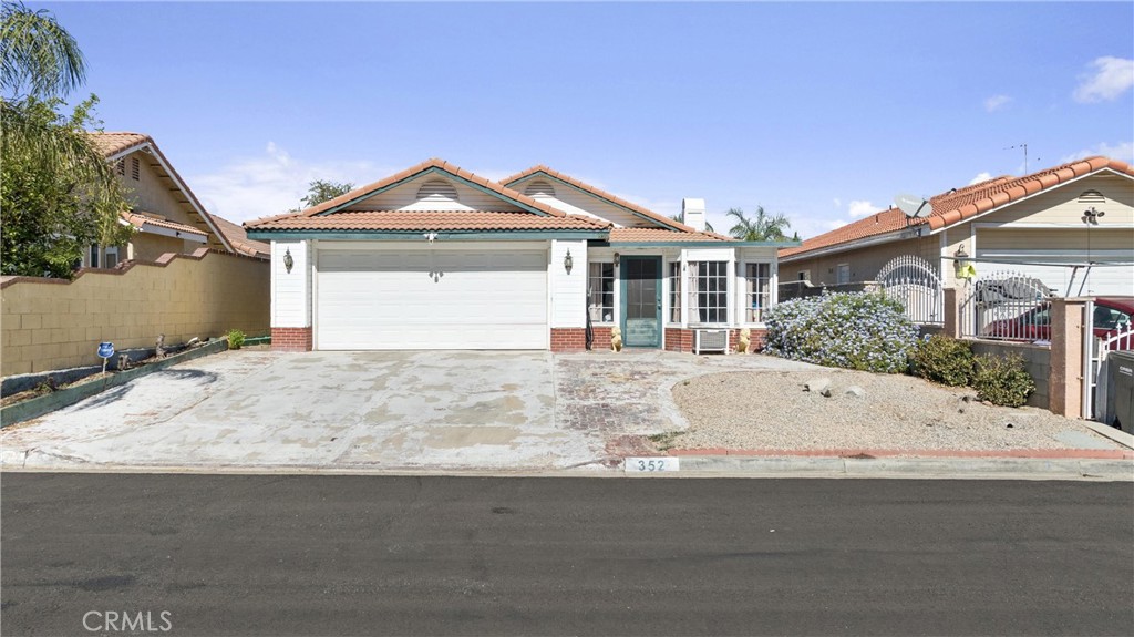 352 Red Spruce Place Perris, CA 92570 - Photo 24 of 30 a front view of a house with a yard and garage