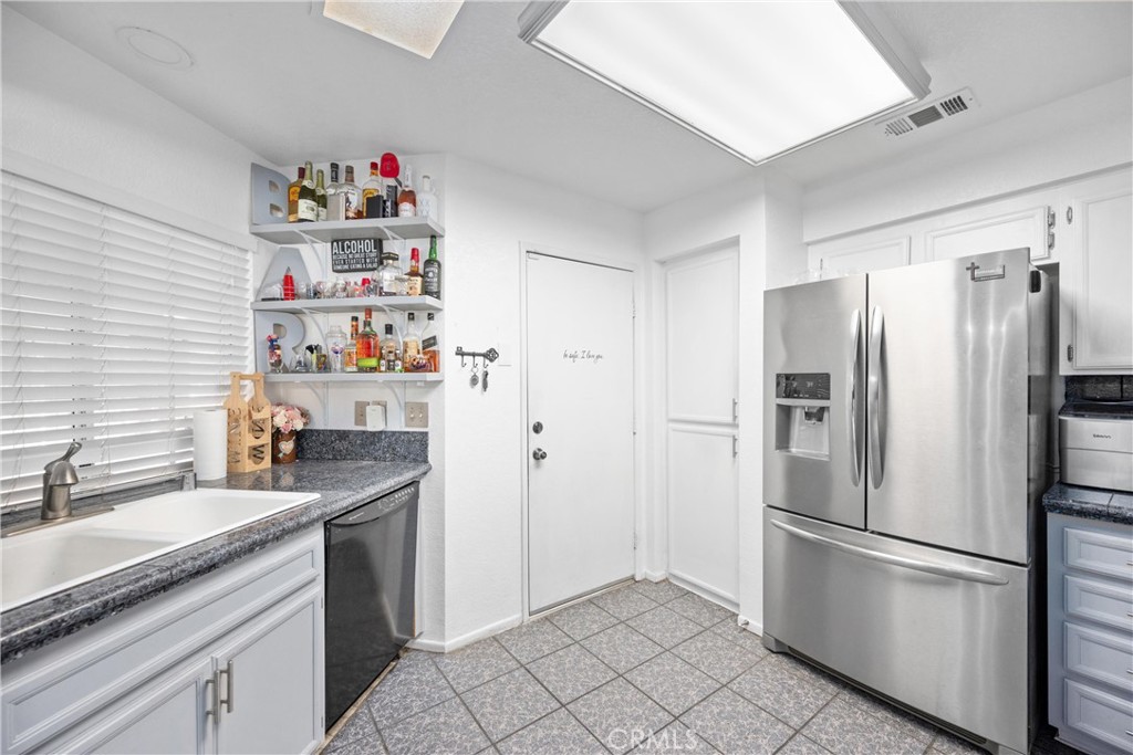 352 Red Spruce Place Perris, CA 92570 - Photo 3 of 30 a kitchen with stainless steel appliances a refrigerator and a sink