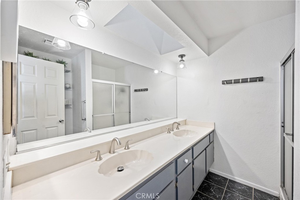 352 Red Spruce Place Perris, CA 92570 - Photo 5 of 30 a bathroom with a double vanity sink mirror and shower