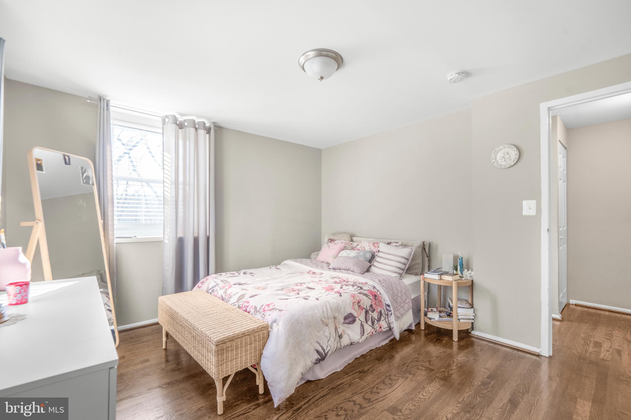 7617 Allendale Circle Landover, MD 20785 - Photo 17 of 26 a bedroom with a bed and wooden floor
