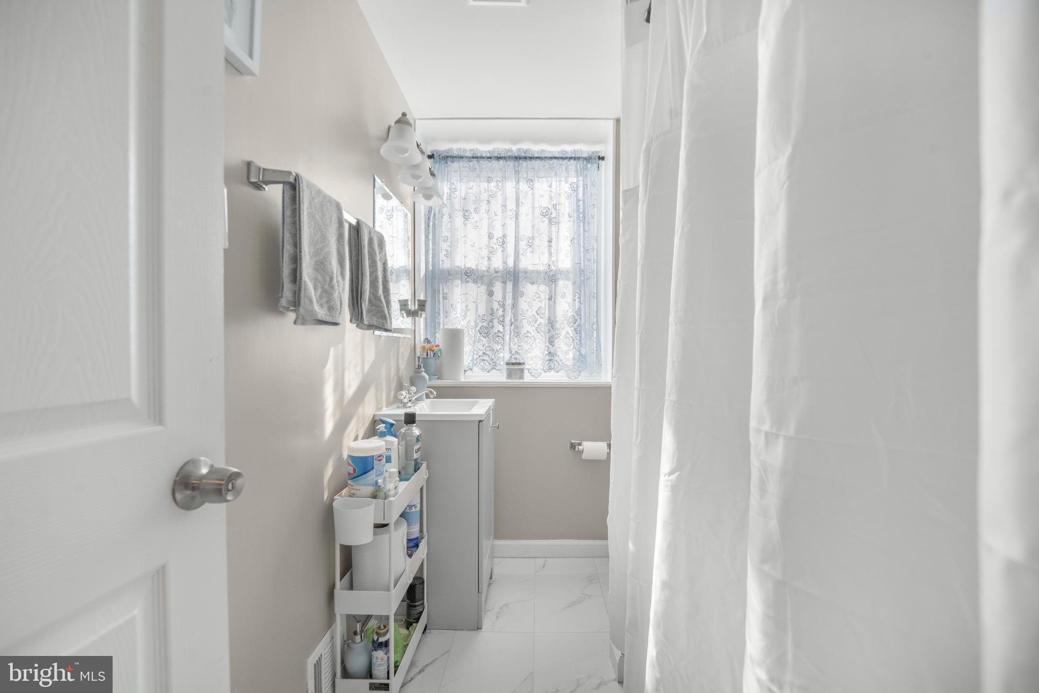 7617 Allendale Circle Landover, MD 20785 - Photo 18 of 26 a bathroom with a bathtub and a shower