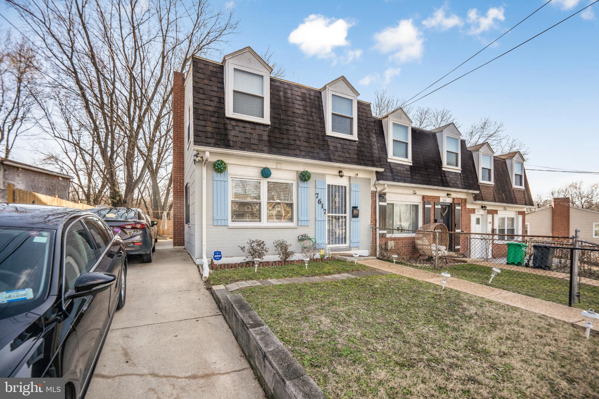 7617 Allendale Circle Landover, MD 20785 - Photo 2 of 26 a view of a brick house with many windows next to a yard