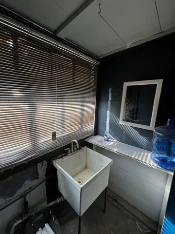 a bathroom with a toilet a sink and bathtub