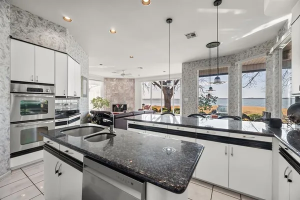 a view of a patio with chairs and floor to ceiling window