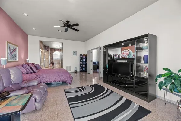 a bedroom with a bed and a chandelier