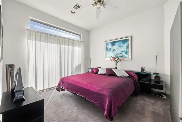 a bedroom with a bed and a view of kitchen