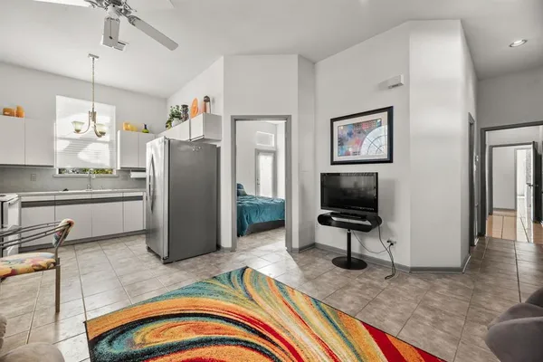 a view of a swimming pool with a table and chairs under an umbrella