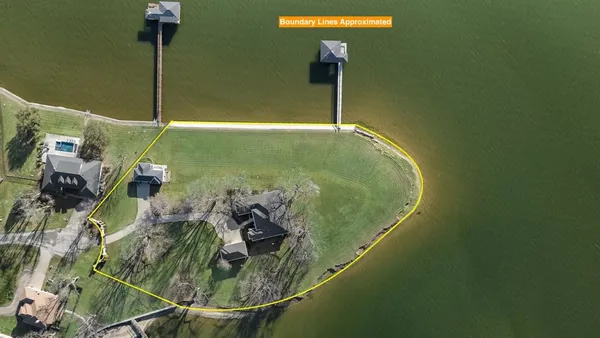 a living room with furniture and floor to ceiling window