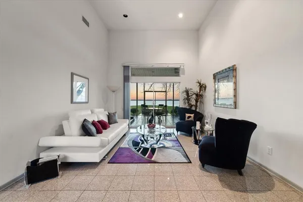 a living room with furniture and a potted plant