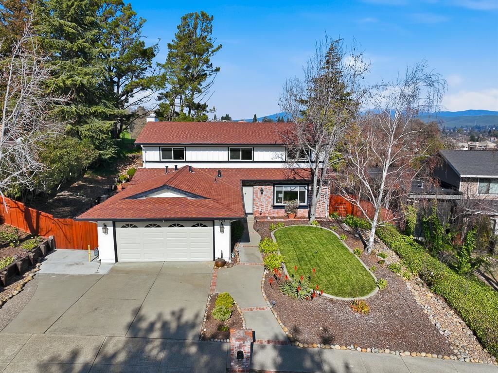 an aerial view of a house with a yard and garage