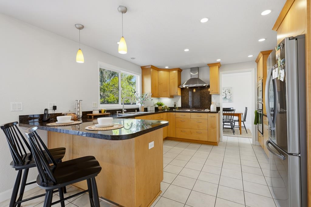 11868 Bloomington Way Dublin, CA 94568 - Photo 15 of 59 a kitchen with stainless steel appliances granite countertop a sink a stove and a refrigerator