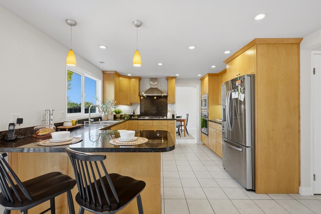 11868 Bloomington Way Dublin, CA 94568 - Photo 17 of 59 a kitchen with a refrigerator and a stove top oven
