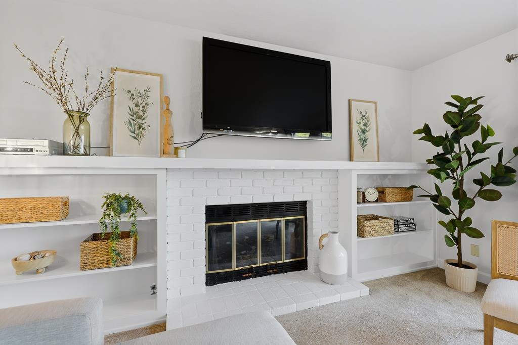 11868 Bloomington Way Dublin, CA 94568 - Photo 26 of 59 a living room with a fireplace and a flat screen tv