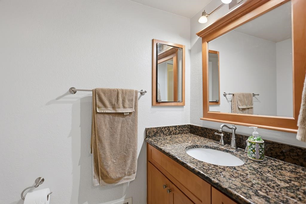11868 Bloomington Way Dublin, CA 94568 - Photo 29 of 59 a bathroom with a granite countertop sink and a mirror