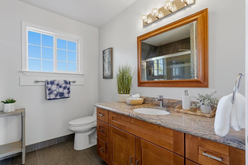 11868 Bloomington Way Dublin, CA 94568 - Photo 35 of 59 a bathroom with a toilet sink and mirror
