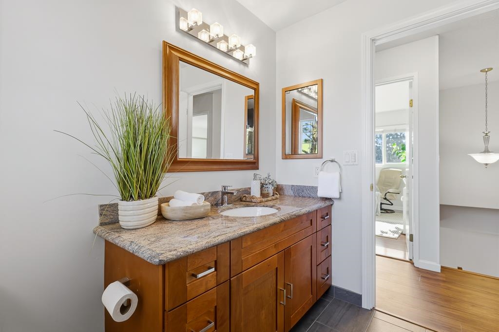 11868 Bloomington Way Dublin, CA 94568 - Photo 36 of 59 a bathroom with a granite countertop sink and a mirror