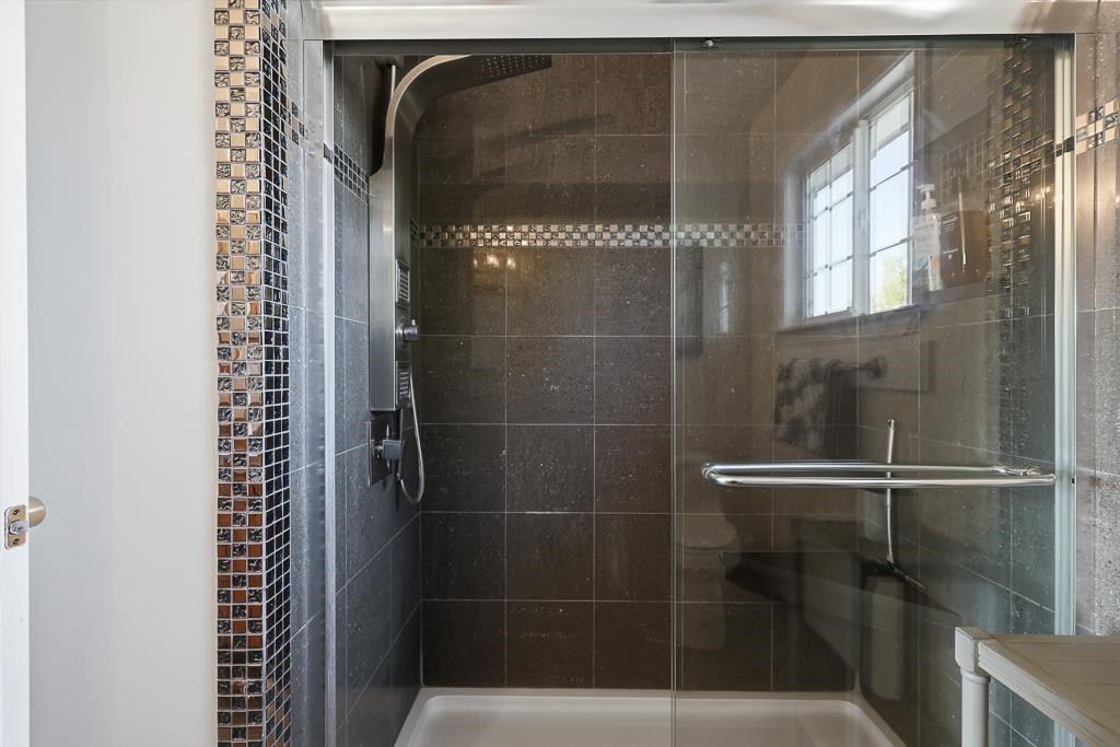 11868 Bloomington Way Dublin, CA 94568 - Photo 37 of 59 a bathroom with a glass shower door