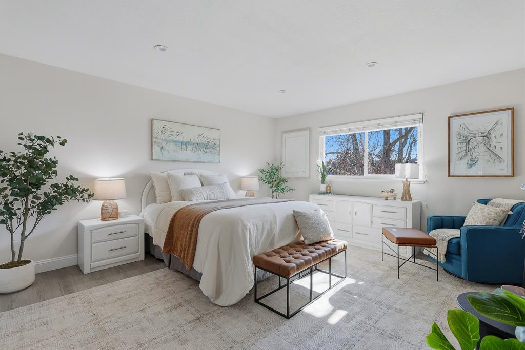 11868 Bloomington Way Dublin, CA 94568 - Photo 42 of 59 a spacious bedroom with a bed a couch and potted plant in it