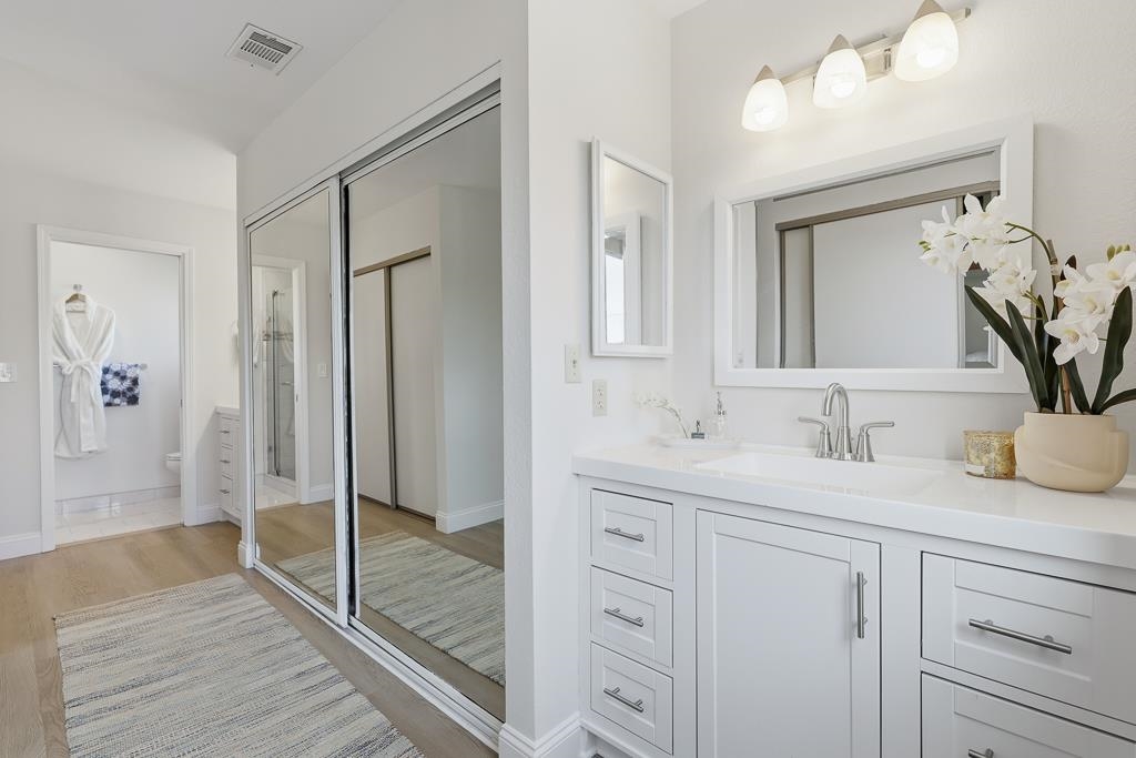 11868 Bloomington Way Dublin, CA 94568 - Photo 45 of 59 a bathroom with a granite countertop sink mirror and shower