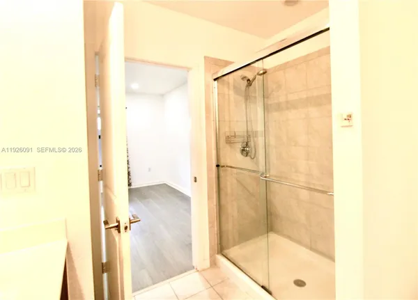 a bathroom with a glass shower door