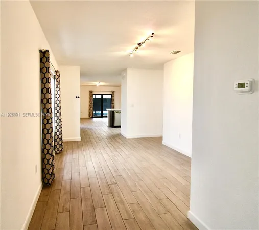 a view of a room with wooden floor