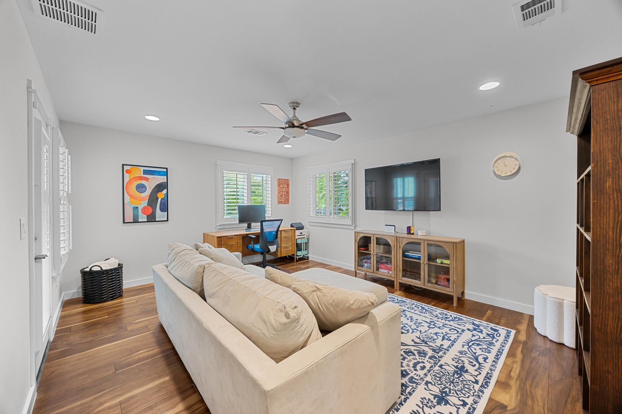 3907 Becker Avenue Austin, TX 78751 - Photo 27 of 37 Secondary living area with custom shutters, wood floors, a ceiling fan, recessed lighting, and an office area.