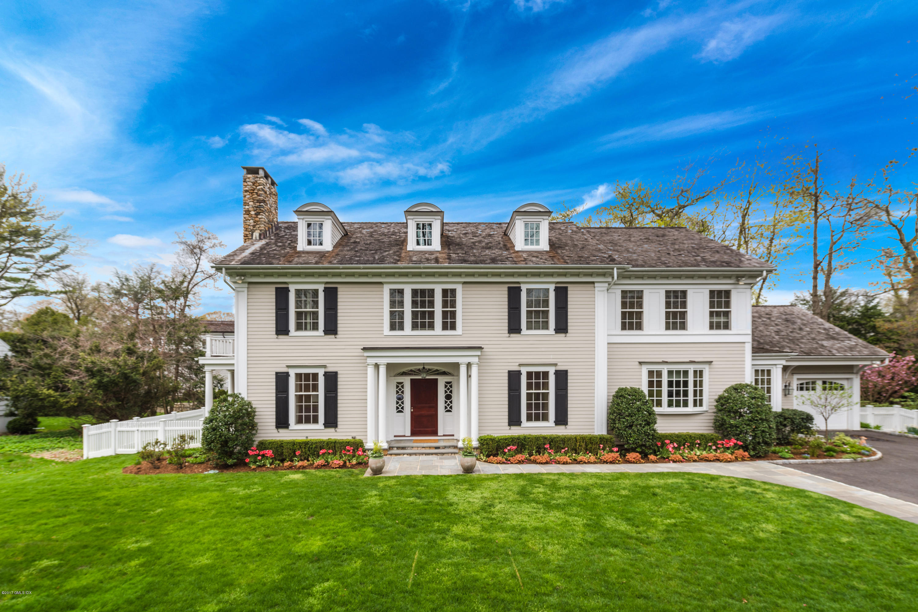 19 Willow Road Riverside, CT 06878 - Photo 2 of 31 a view of a white house with a big yard and potted plants