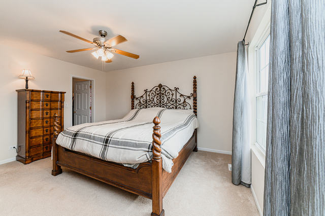 604 Springbrook Trail North Oswego, IL 60543 - Photo 13 of 22 a bedroom with a bed dresser and a window