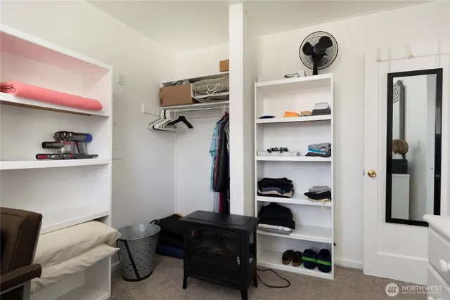 a bedroom with a bed and a book shelf